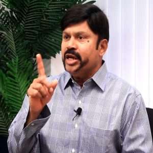 K C Palanisamy showing his hand